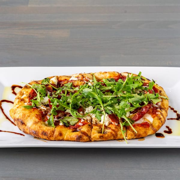Hutchinson Island Bar and Grille's flatbread pizza topped with arugula, cheese, and sun-dried tomatoes.