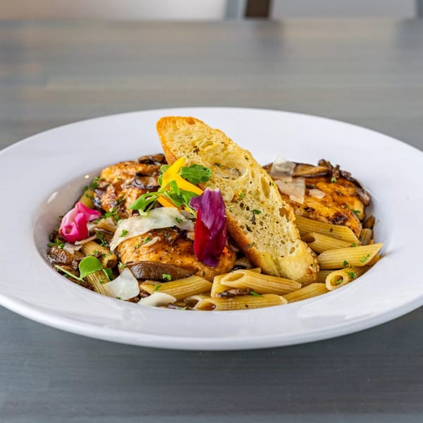 Hutchinson Island Bar and Grille's chicken and penne pasta with mushrooms, cheese, and garlic bread.